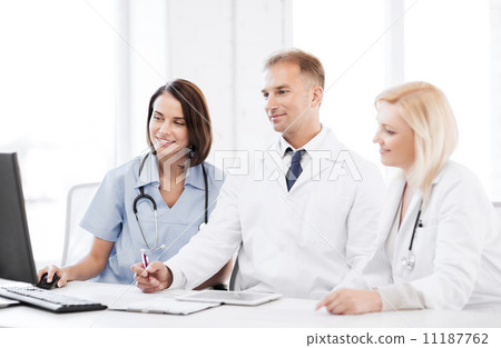 doctors looking at computer on meeting doctors looking at computer on meeting 11187762