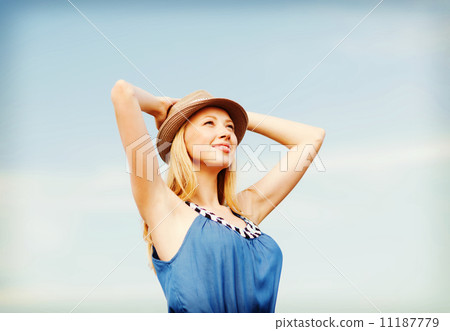 girl in hat standing on the beach girl in hat standing on the beach 11187779