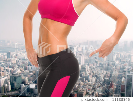 close up of sporty woman pointing at her buttocks close up of sporty woman pointing at her buttocks 11188546