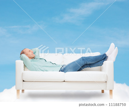 smiling man lying on sofa smiling man lying on sofa 11188750