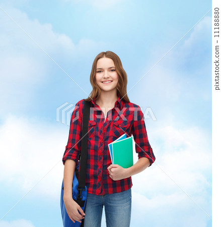 smiling female student with bag and notebooks smiling female student with bag and notebooks 11188880