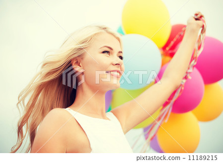 woman with colorful balloons outside woman with colorful balloons outside 11189215