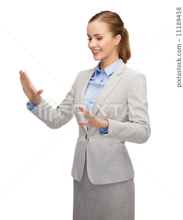smiling businesswoman pointing to something 11189458