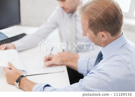 businessmen with notebook on meeting businessmen with notebook on meeting 11189538