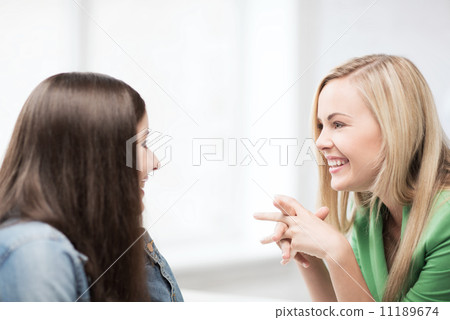 student girls gossiping at school 11189674