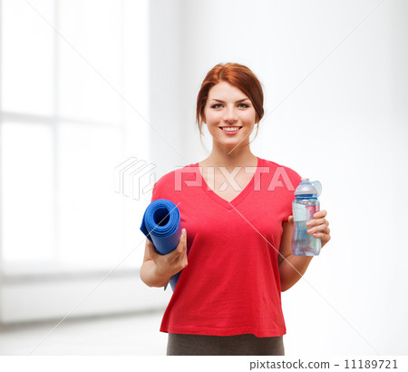 smiling girl with bottle of water after exercising smiling girl with bottle of water after exercising 11189721