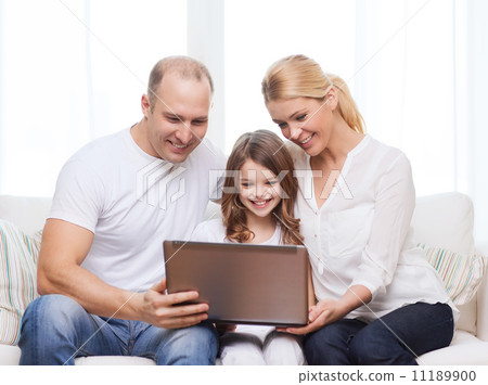 parents and little girl with laptop at home 11189900