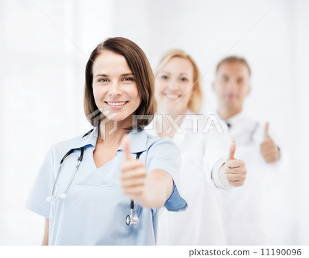 team of doctors showing thumbs up 11190096