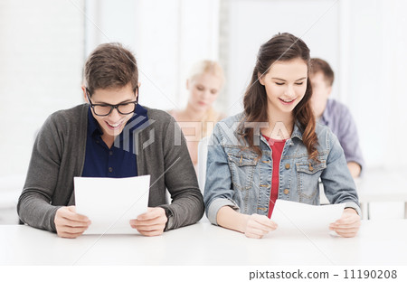 two teenagers looking at test or exam results 11190208