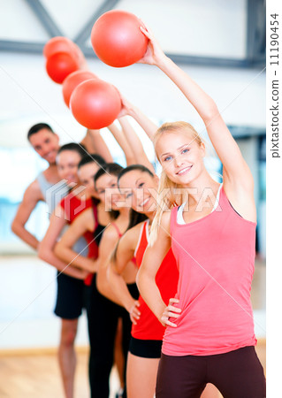 group of smiling people working out with ball 11190454