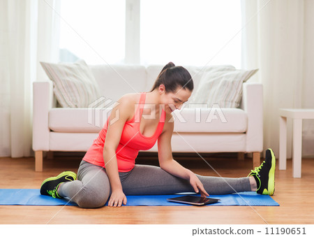 smiling teenage girl streching on floor at home 11190651