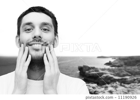 beautiful smiling man touching his face beautiful smiling man touching his face 11190926