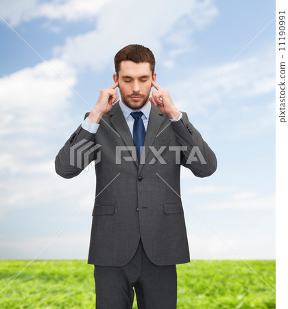 annoyed businessman covering ears with his hands 11190991