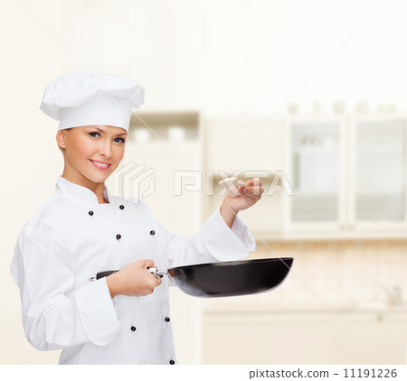 smiling female chef with pan and spoon 11191226