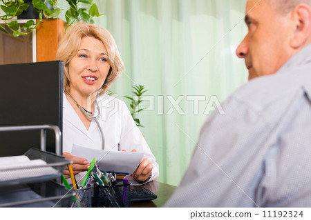 Mature doctor talking with elderly male patient 11192324