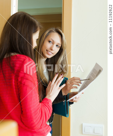 young employee polling among people at door young employee polling among people at door 11192622