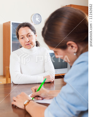 Sad mature woman answer questions 11192682