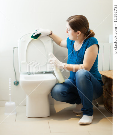 girl cleaning toilet seat with sponge and cleaner girl cleaning toilet seat with sponge and cleaner 11192752