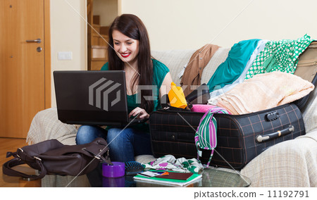 Happy brunette woman reserving hotel in internet Happy brunette woman reserving hotel in internet 11192791