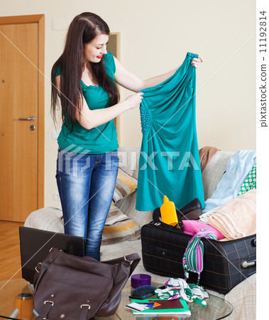 brunette girl choosing dress for vacation 11192814