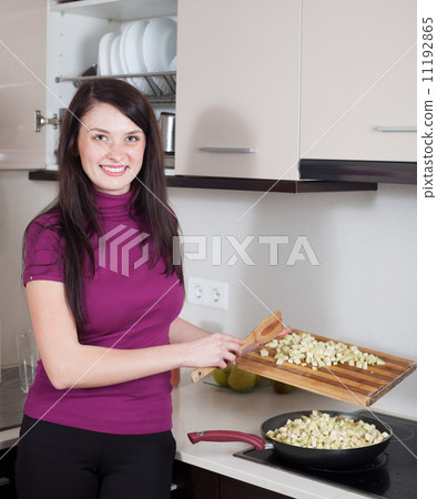 girl frying eggplant in griddle girl frying eggplant in griddle 11192865