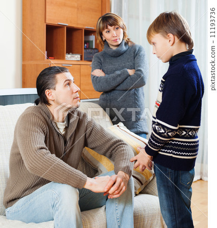 Mother and father together scolding son 11193736