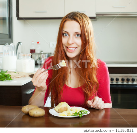 positive girl eating jacket potatoes 11193831