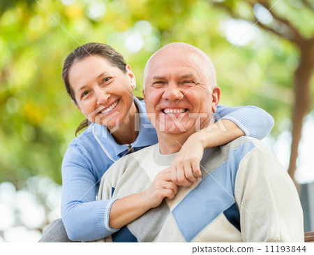 Happy senior man and mature woman against the park 11193844