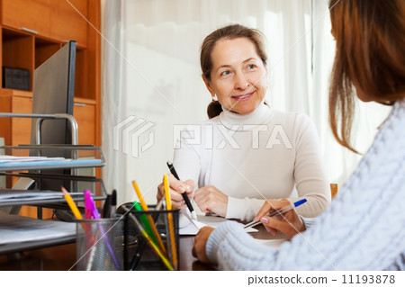 Young girl answering questions of with computer employee Young girl answering questions of with computer employee 11193878