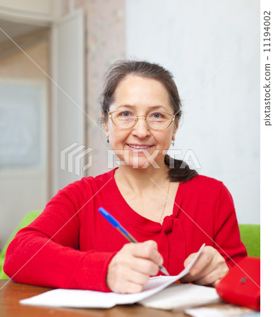 mature woman counts family budget 11194002