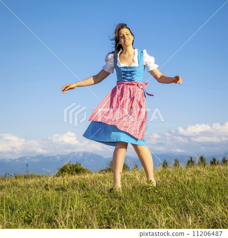 woman in bavarian traditional dirndl 11206487