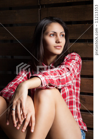 young woman in cowboy clothes over wood 11213353