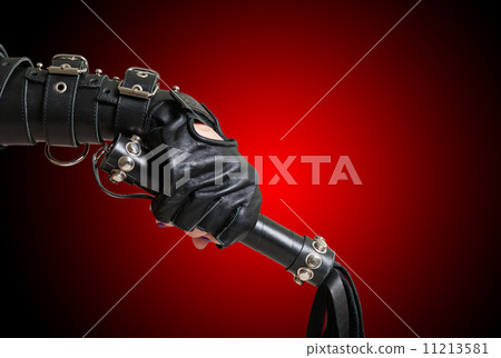 Fist in leather glove with lash Fist in leather glove with lash 11213581
