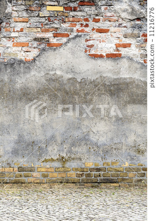old plastered red brick wall with pavement 11216776