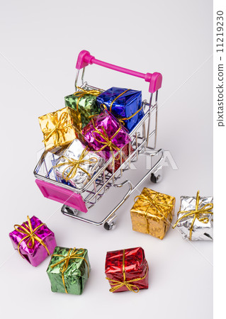 Christmas gifts in shopping trolley, isolated on white 11219230