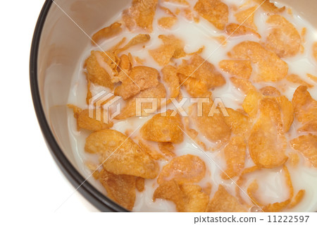 Bowl with corn flakes and milk on the white background Bowl with corn flakes and milk on the white background 11222597