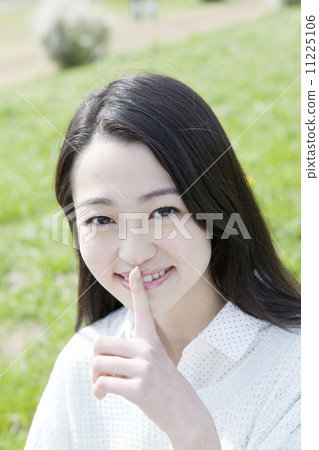 A young woman smiling at the park 11225106