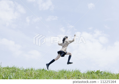 School girl who jumps with blue sky 11225164