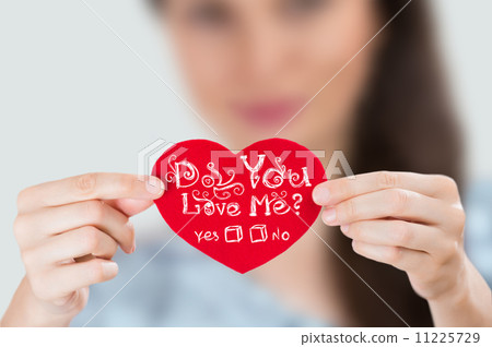 Woman holding red heart with question: Do you love Me? Woman holding red heart with question: Do you love Me? 11225729