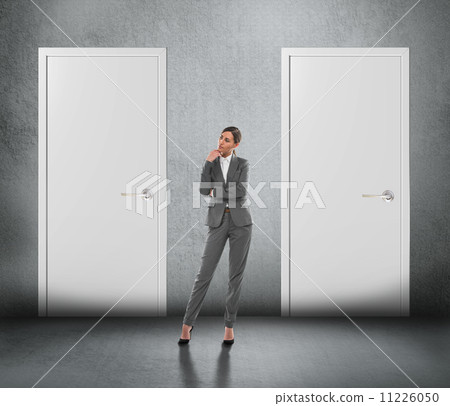 Businesswoman choosing right door 11226050