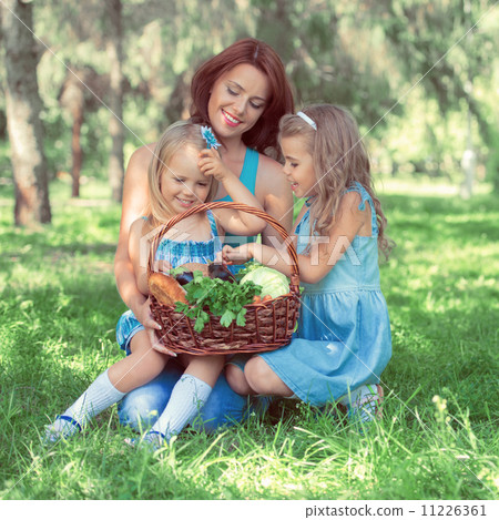 Mother with two daughters in the park 11226361