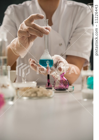 Researcher holding glass test-tube Researcher holding glass test-tube 11226443