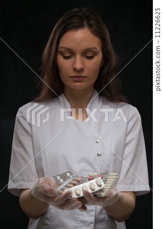 Female doctor holding pills Female doctor holding pills 11226625