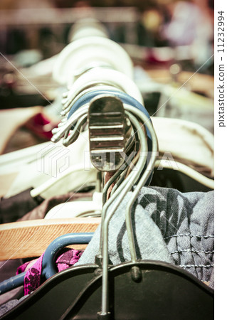clothes on a rack on a flea market 11232994