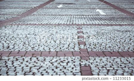 cobblestone pavement with white arrows 11233015