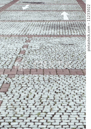 cobblestone pavement with white arrows cobblestone pavement with white arrows 11233022