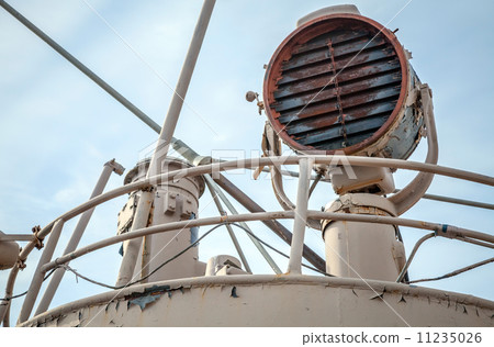 Rusted signal light mounted on captain bridge of an old ship 11235026