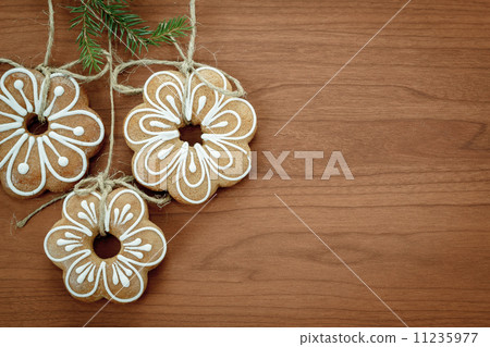 Gingerbread cookies hanging over wooden background 11235977
