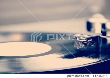 Spinning vinyl record. Motion blur image. Vintage toned. Spinning vinyl record. Motion blur image. Vintage toned. 11236083