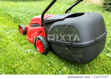 new lawnmower on green grass new lawnmower on green grass 11237757